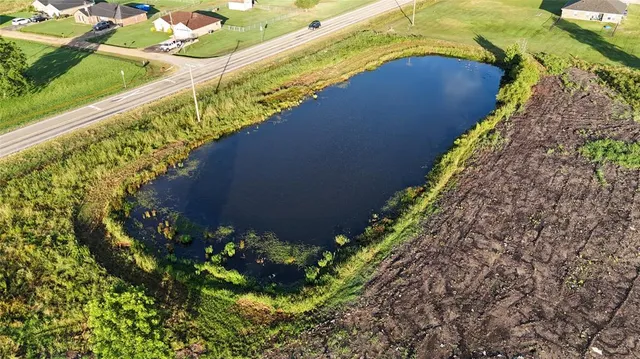 a view of a green field with lots of trees