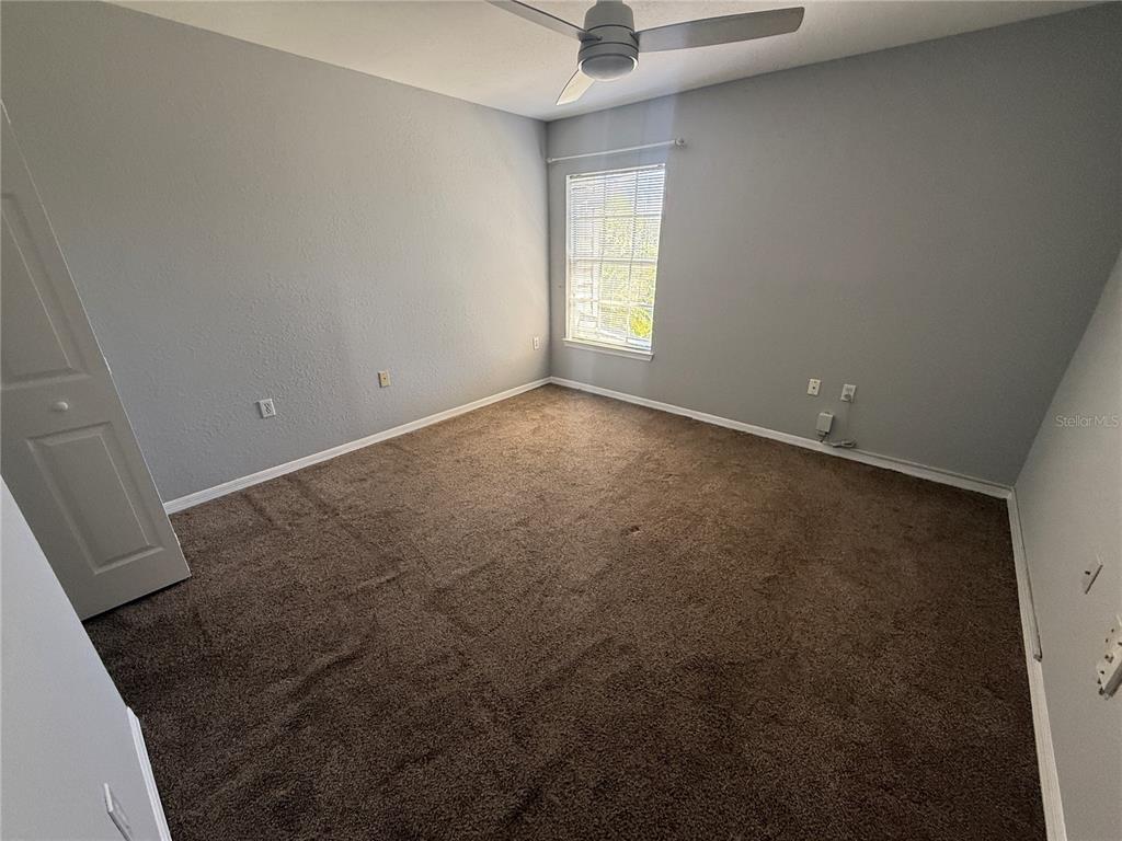 8932 Manor Loop, Unit 205 Lakewood Ranch, FL 34202 - Photo 5 of 15 an empty room with windows and closet