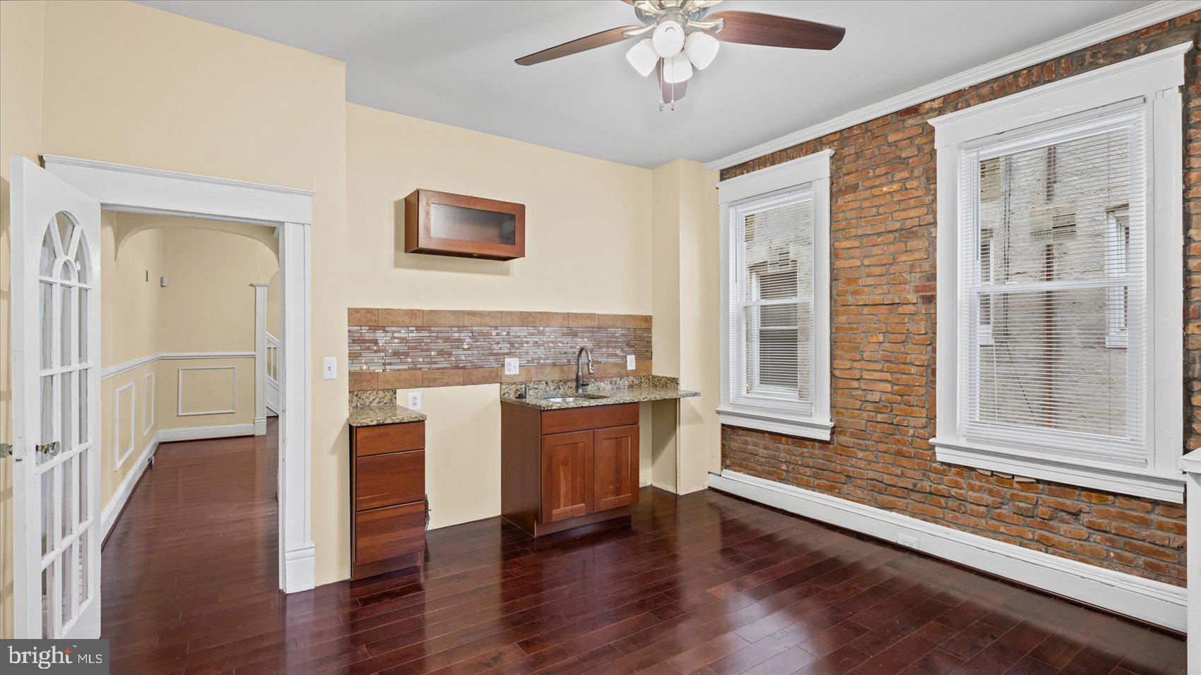 2413 Madison Avenue Baltimore, MD 21217 - Photo 11 of 48 a view of a hallway with wooden floor and a kitchen