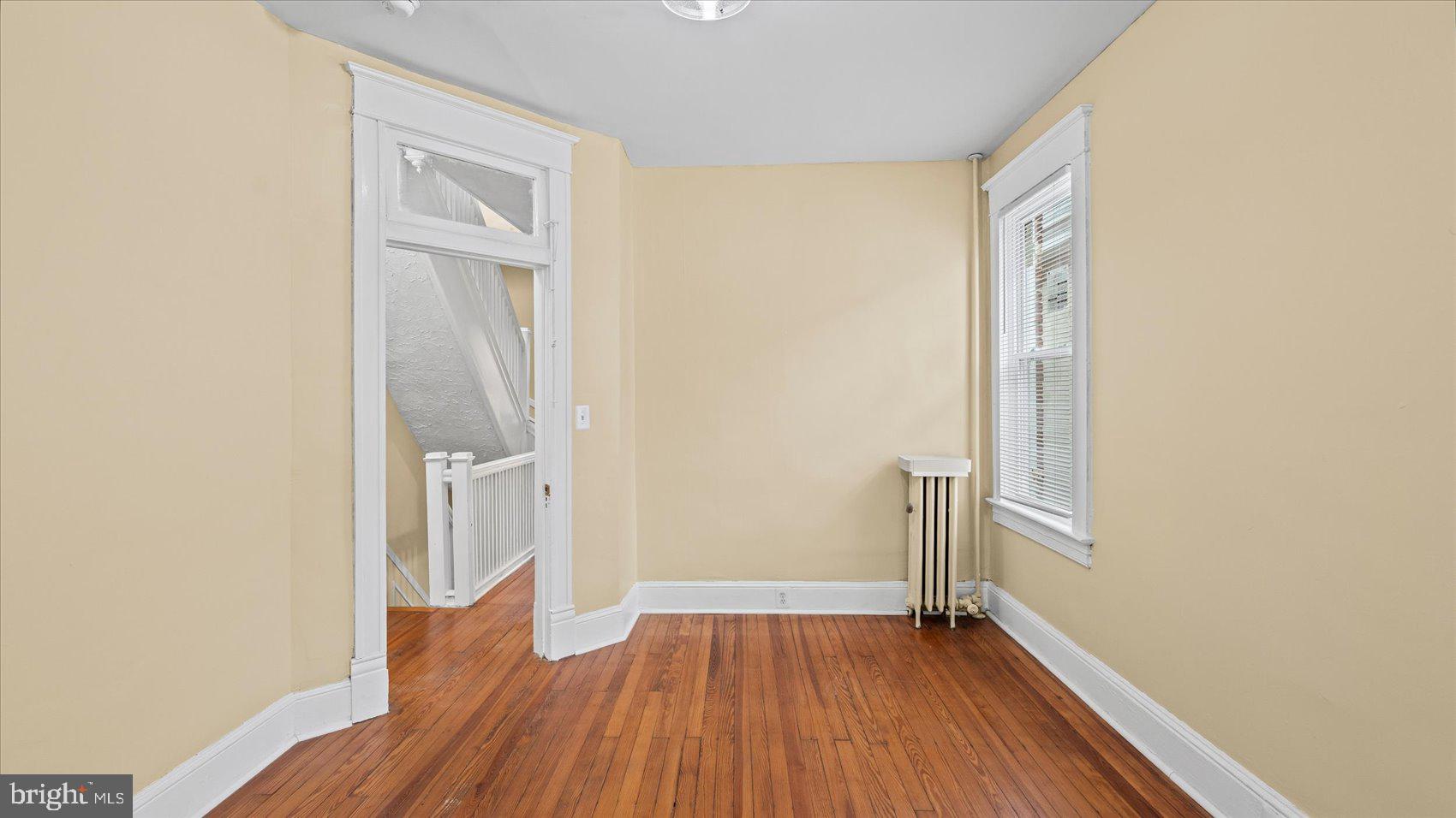 2413 Madison Avenue Baltimore, MD 21217 - Photo 15 of 48 wooden floor in an empty room