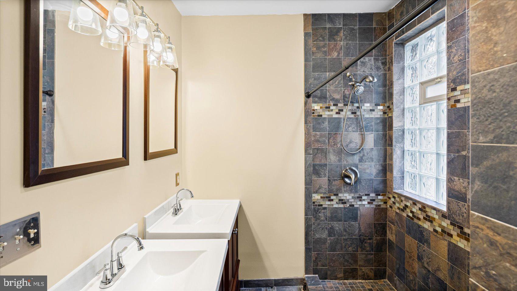 2413 Madison Avenue Baltimore, MD 21217 - Photo 25 of 48 a bathroom with a sink and a mirror