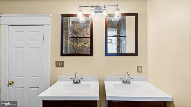 a bathroom with a sink and mirror