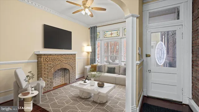 a living room with furniture a fireplace and a flat screen tv