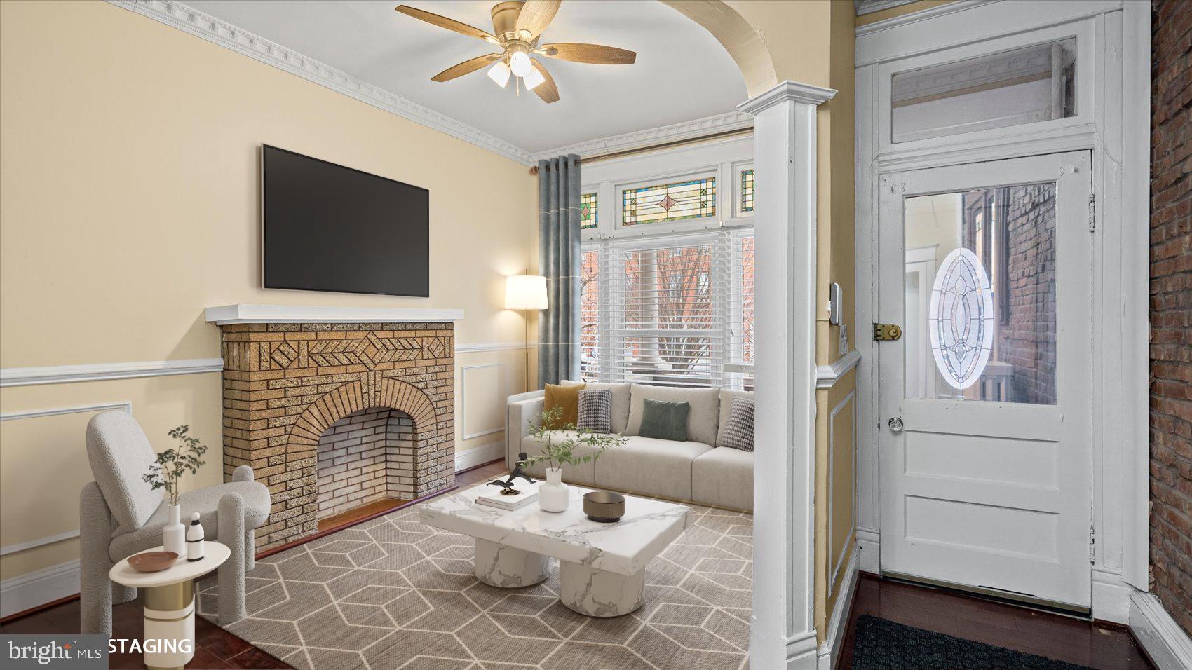 2413 Madison Avenue Baltimore, MD 21217 - Photo 3 of 48 a living room with furniture a fireplace and a flat screen tv