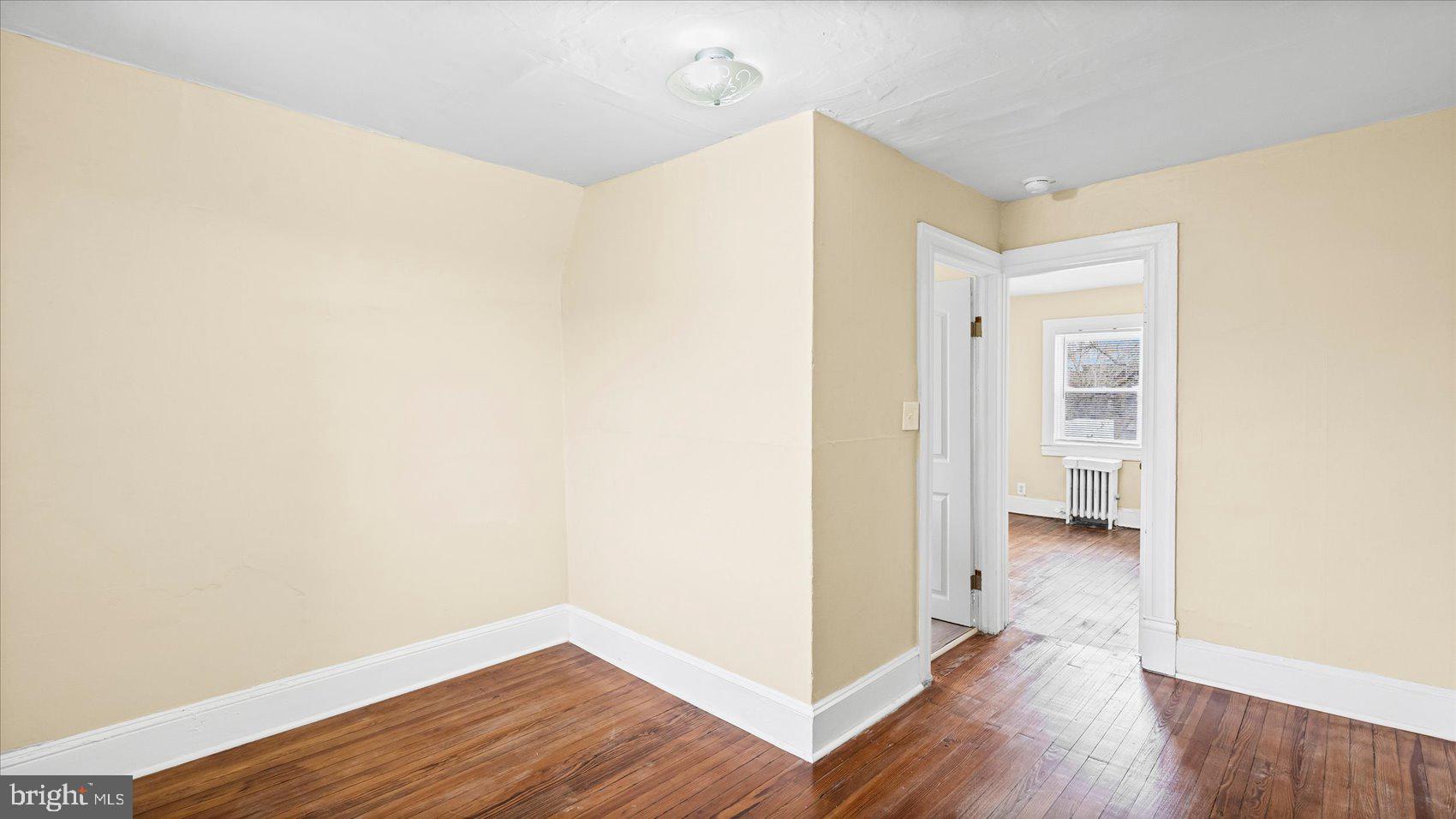 2413 Madison Avenue Baltimore, MD 21217 - Photo 31 of 48 a view of a hallway with wooden floor