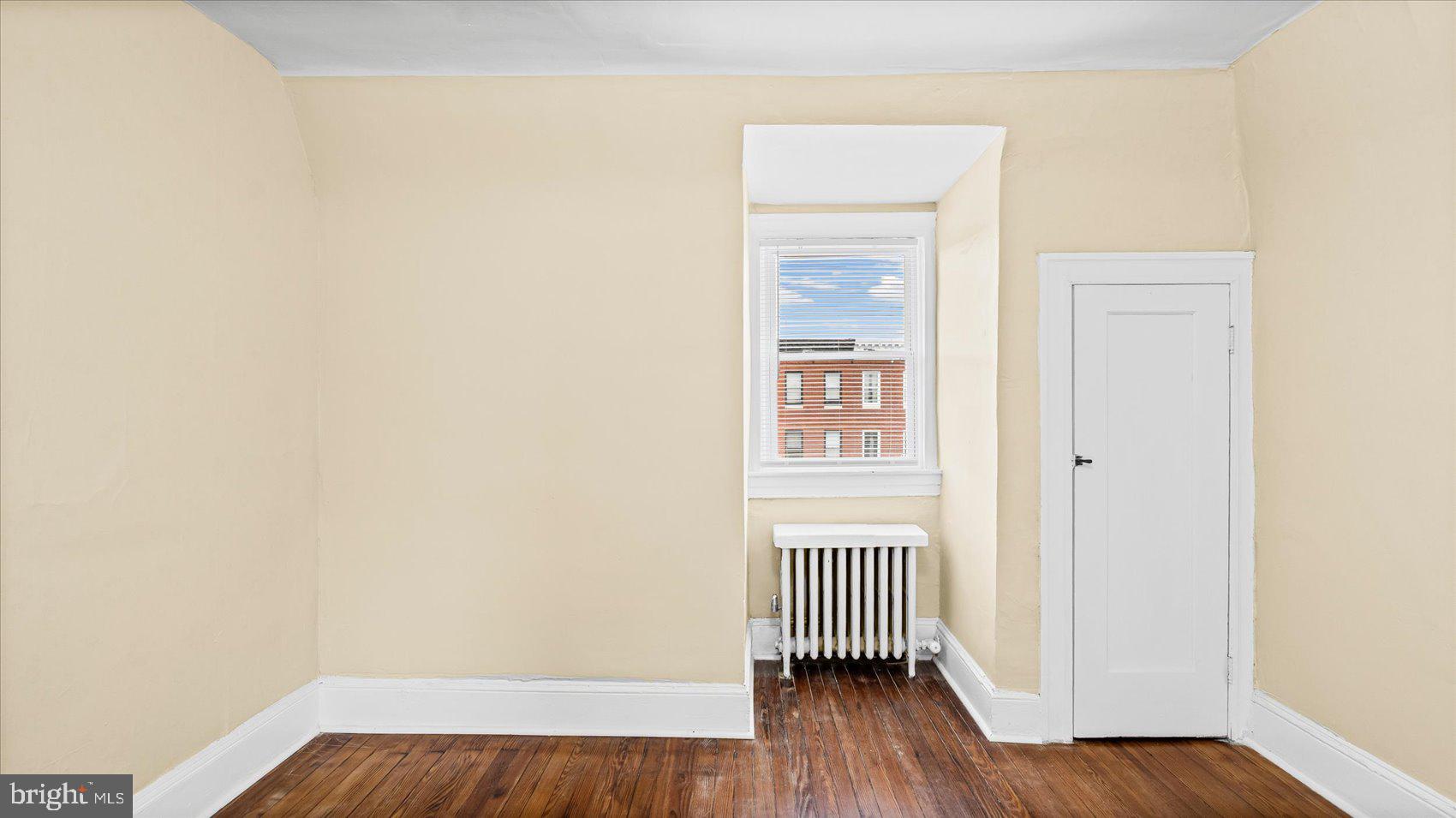 2413 Madison Avenue Baltimore, MD 21217 - Photo 32 of 48 a view of a room with wooden floor and a window