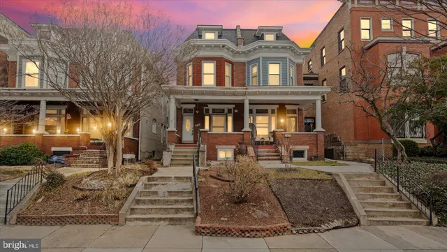 a front view of a residential apartment building with a yard