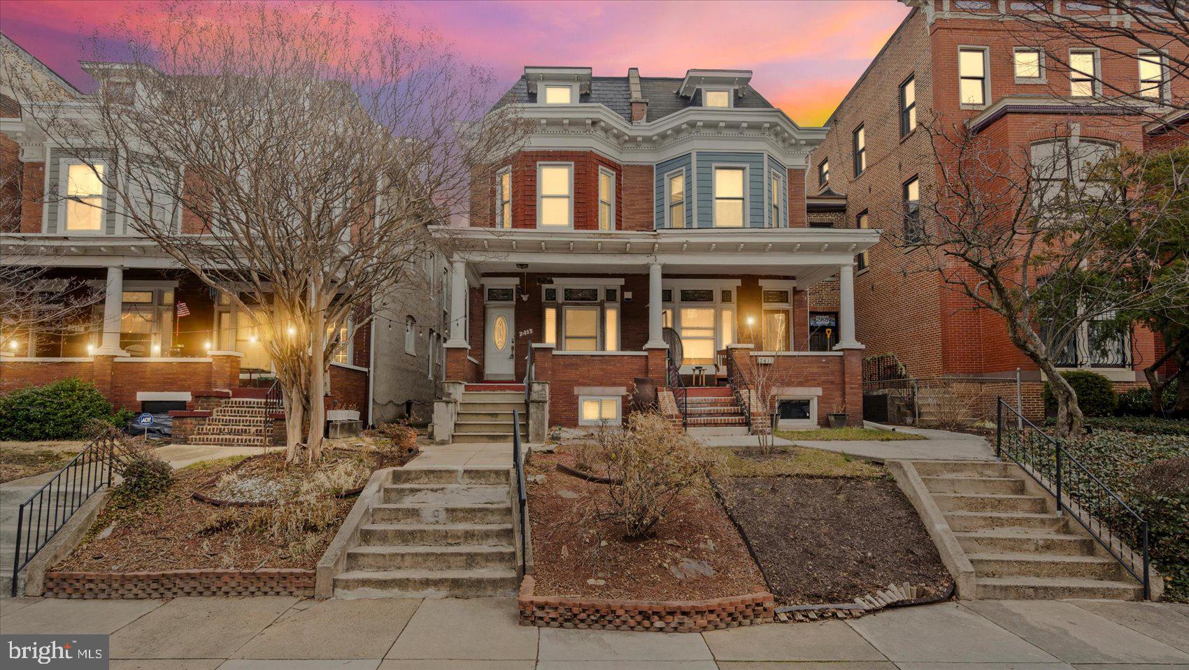 2413 Madison Avenue Baltimore, MD 21217 - Photo 35 of 48 a front view of a residential apartment building with a yard