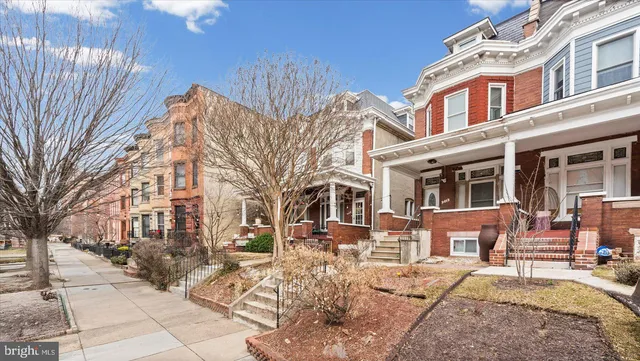 a view of a building with a bench in front of building
