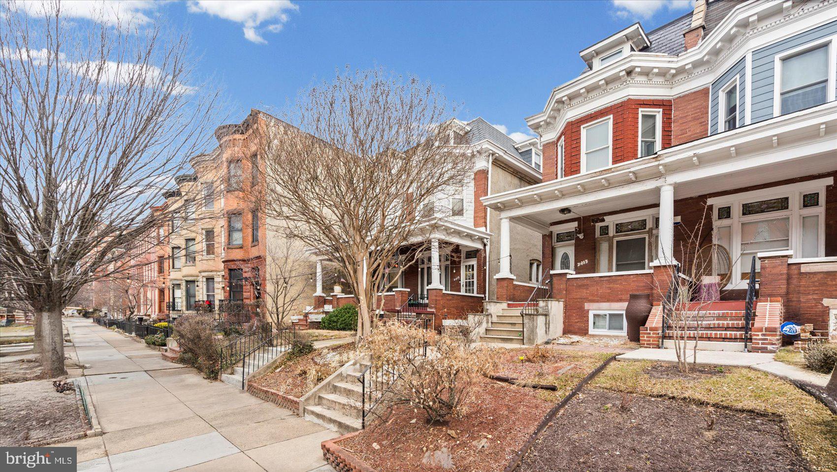 2413 Madison Avenue Baltimore, MD 21217 - Photo 36 of 48 a view of a building with a bench in front of building