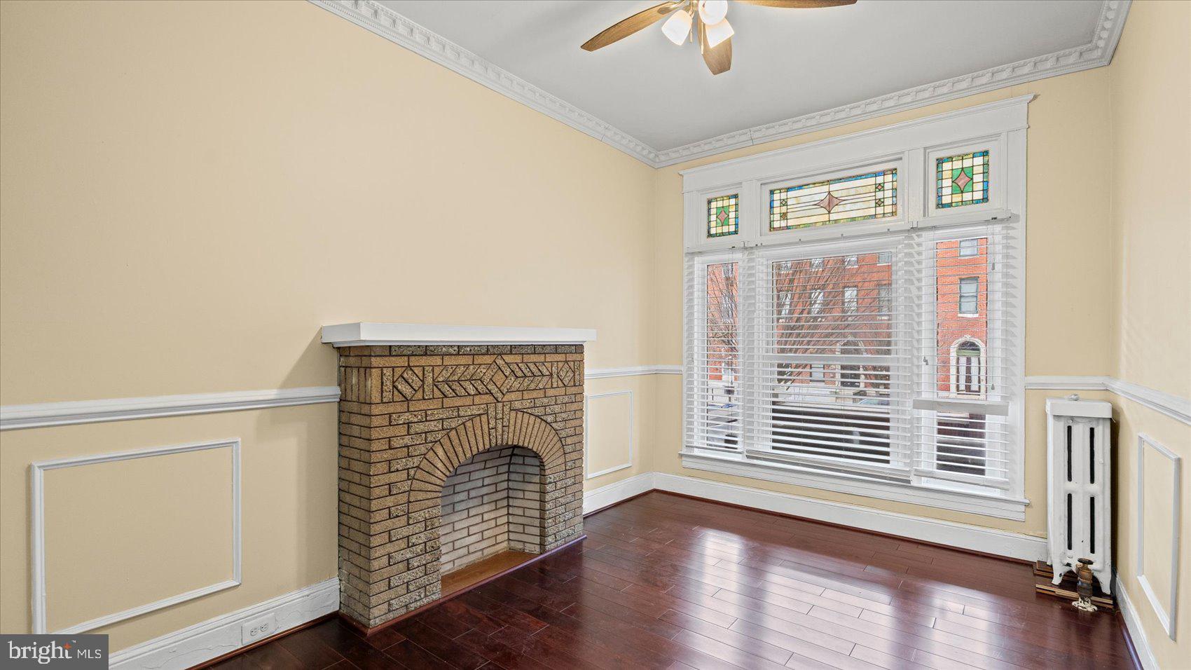 2413 Madison Avenue Baltimore, MD 21217 - Photo 4 of 48 a view of an empty room with wooden floor and a window