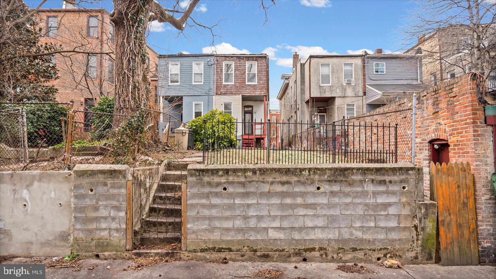 2413 Madison Avenue Baltimore, MD 21217 - Photo 43 of 48 a front view of a house with a yard