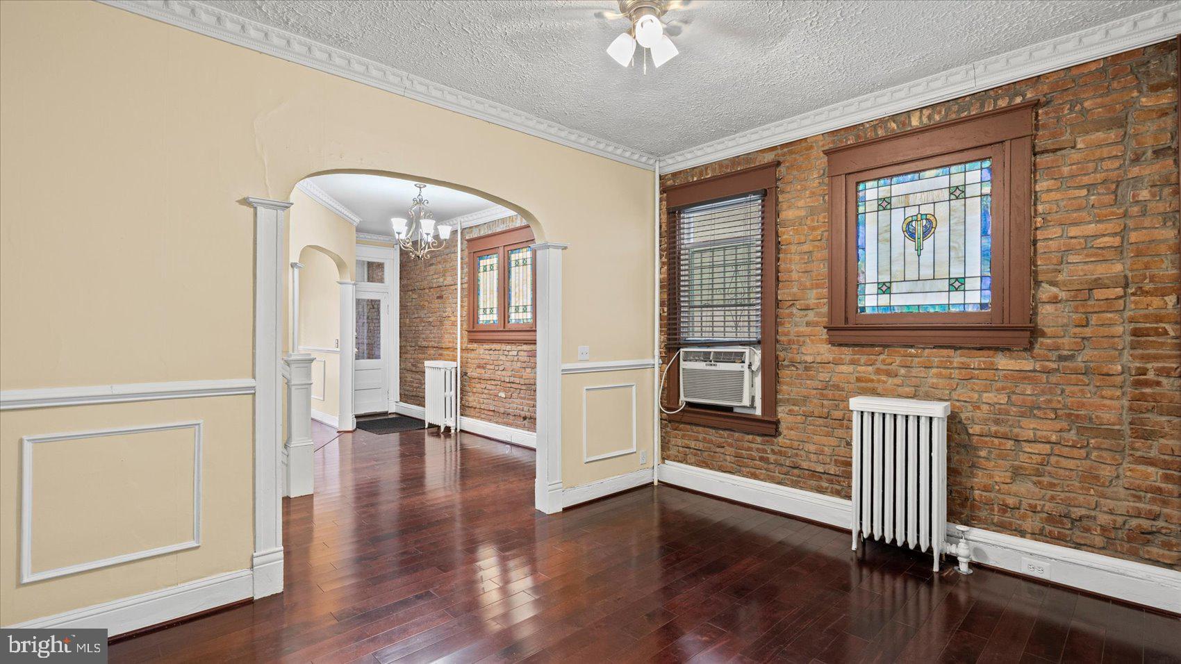2413 Madison Avenue Baltimore, MD 21217 - Photo 8 of 48 wooden floor in an empty room with a window