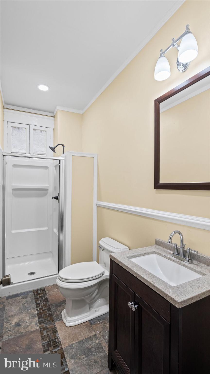 2413 Madison Avenue Baltimore, MD 21217 - Photo 9 of 48 a bathroom with a sink a toilet and shower