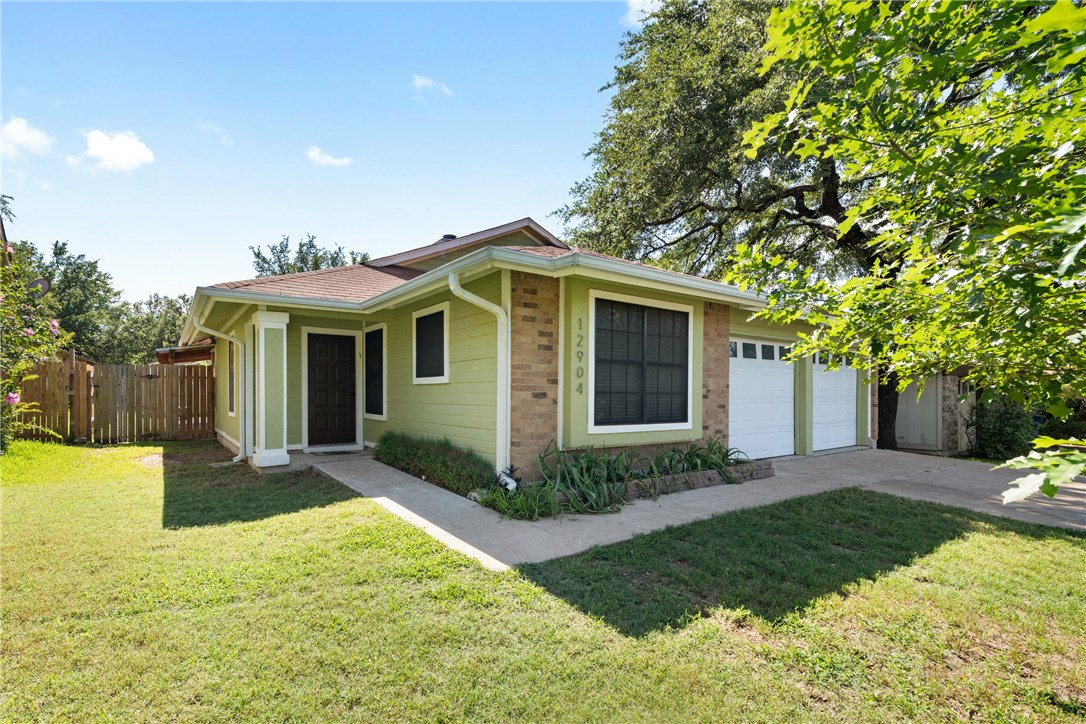 12904 Quinn Trail Austin, TX 78727 - Photo 1 of 1 a front view of a house with a yard and potted plants