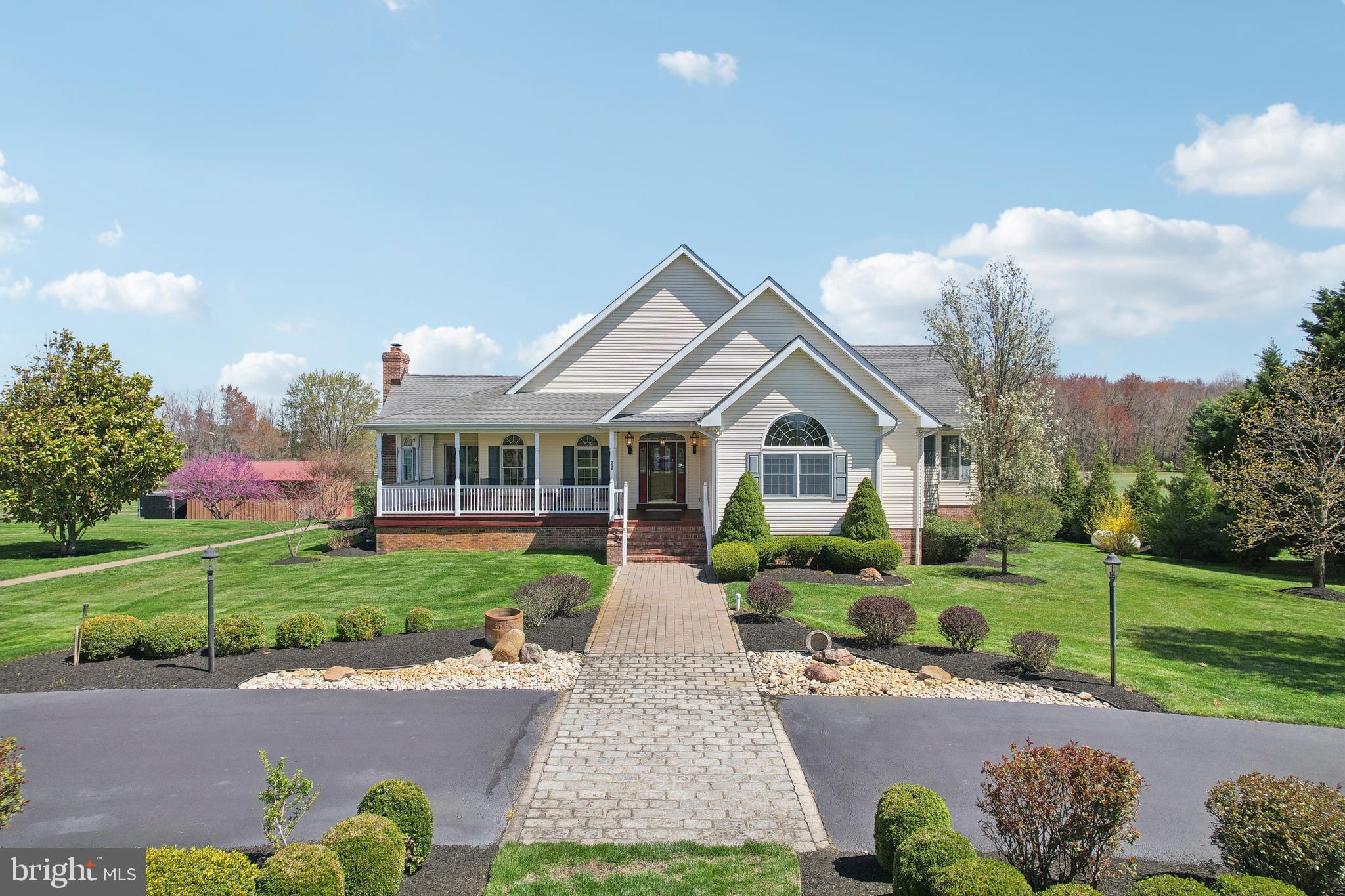 a front view of house with yard and green space
