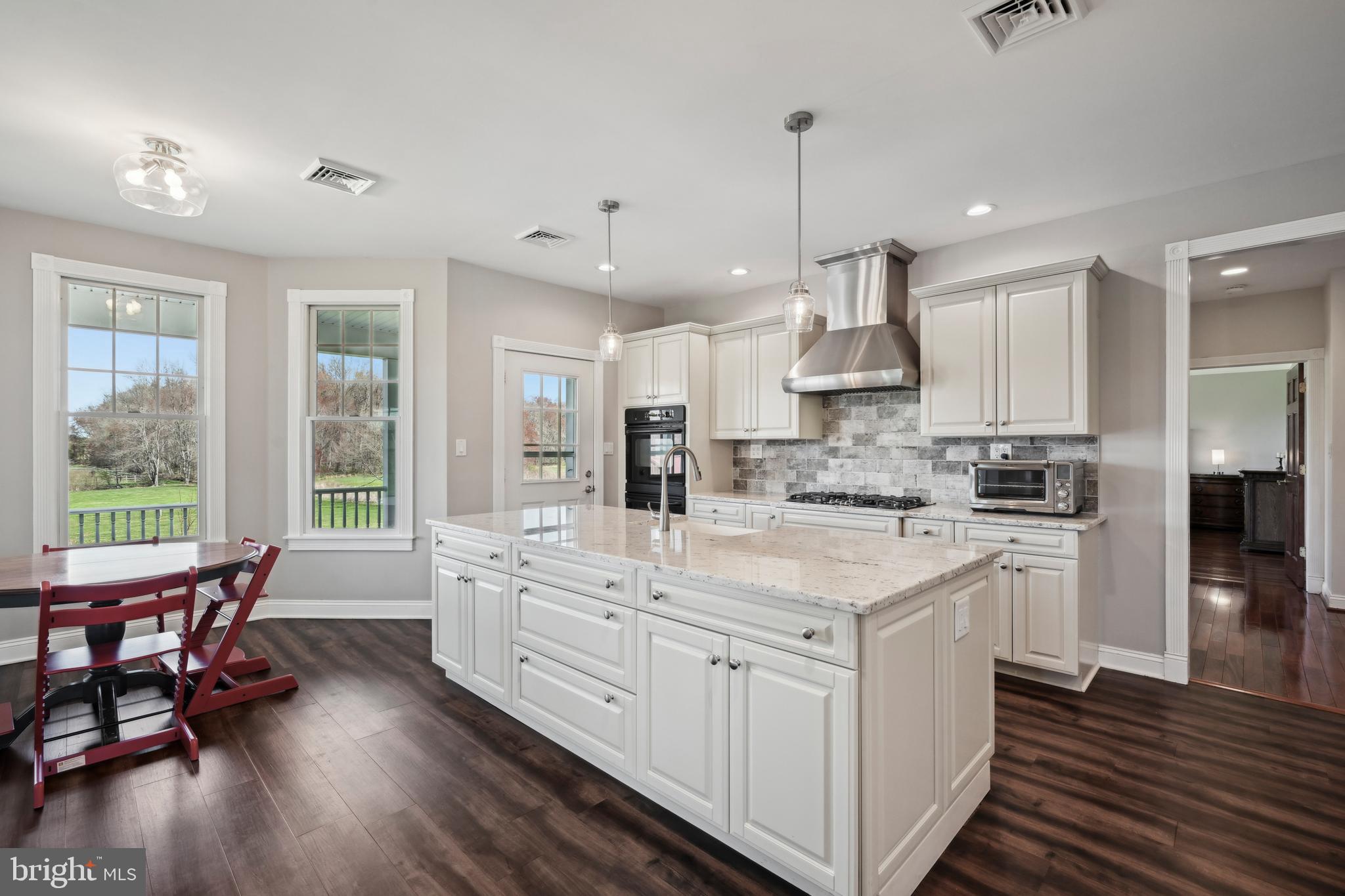 358 Eayrestown Road Southampton, NJ 08088 - Photo 11 of 54 a kitchen with stainless steel appliances granite countertop a stove a sink dishwasher a refrigerator and white cabinets with wooden floor