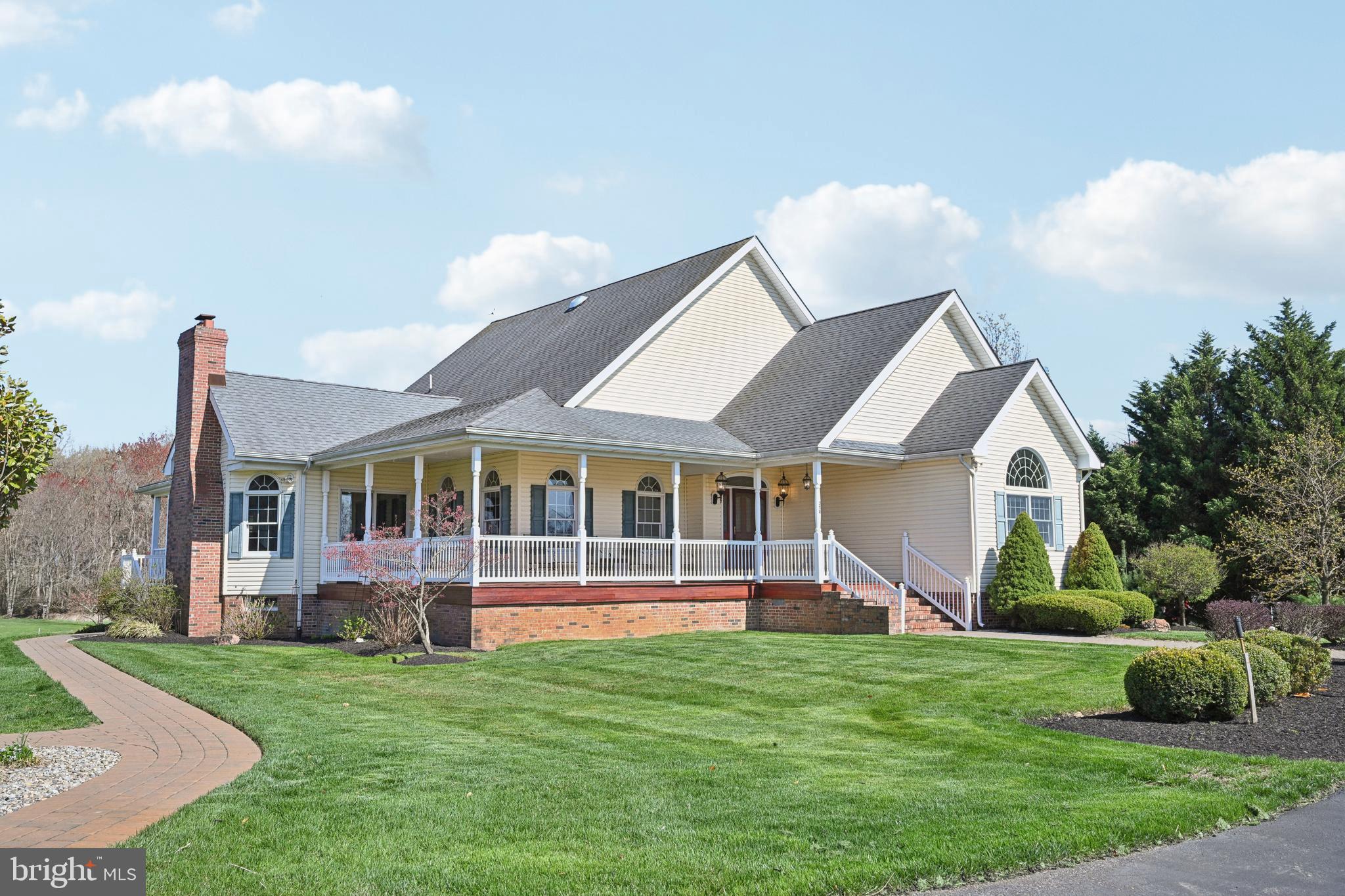 358 Eayrestown Road Southampton, NJ 08088 - Photo 3 of 54 a front view of a house with a yard table and chairs
