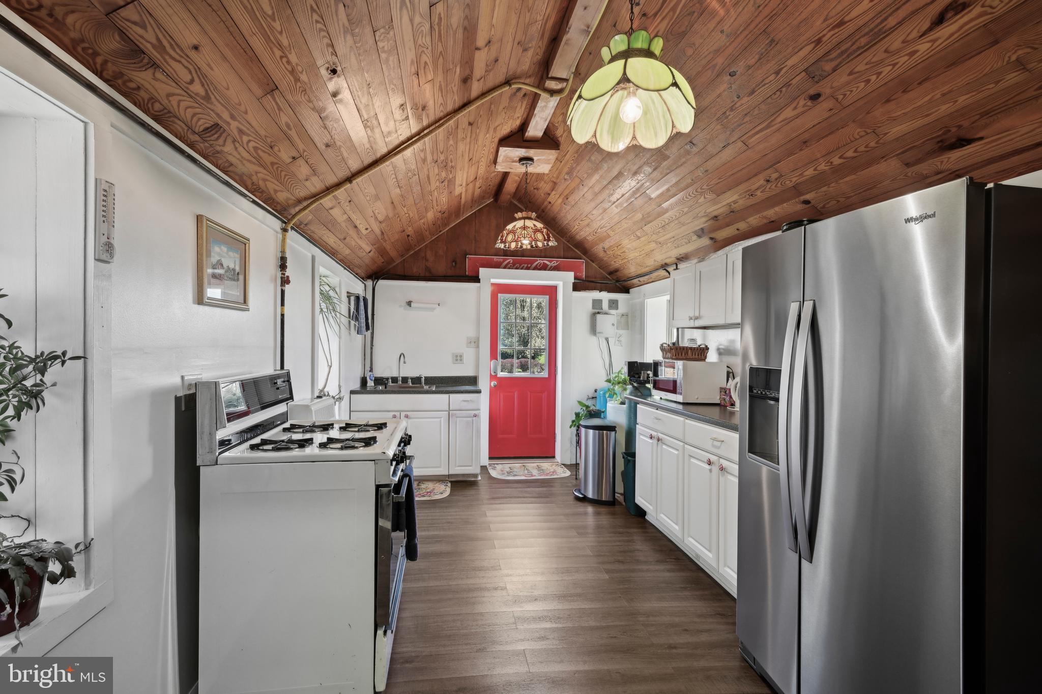 358 Eayrestown Road Southampton, NJ 08088 - Photo 36 of 54 a kitchen with stainless steel appliances granite countertop a stove a refrigerator a sink dishwasher and white cabinets with wooden floor
