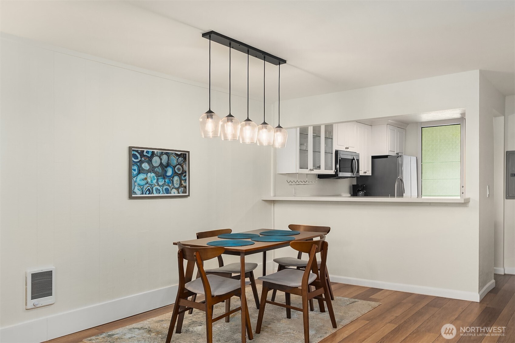 6582 137th Avenue Northeast, Unit 414 Redmond, WA 98052 - Photo 11 of 28 a kitchen with stainless steel appliances a dining table chairs and wooden floor