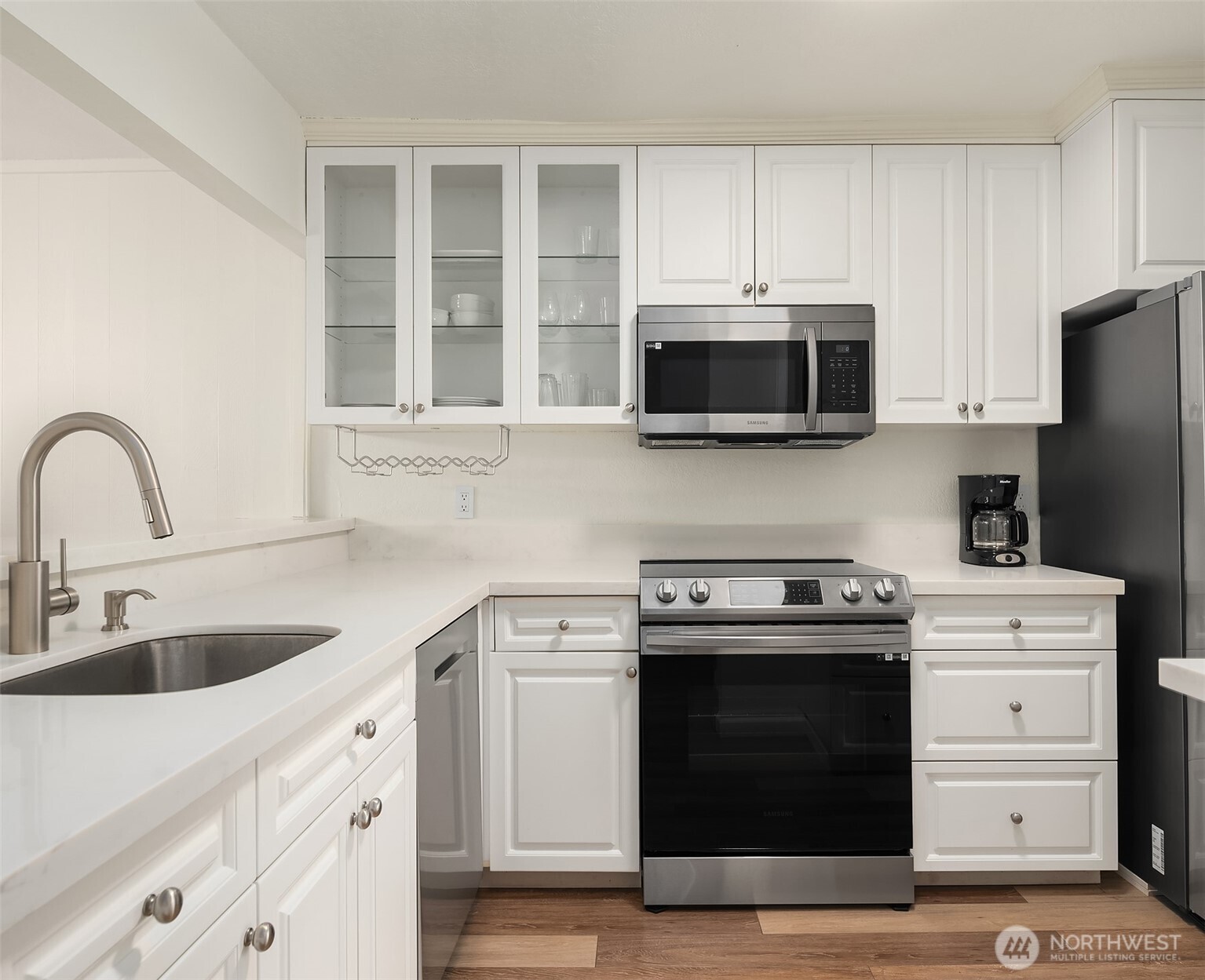 6582 137th Avenue Northeast, Unit 414 Redmond, WA 98052 - Photo 14 of 28 a kitchen with stainless steel appliances a stove a microwave and cabinets