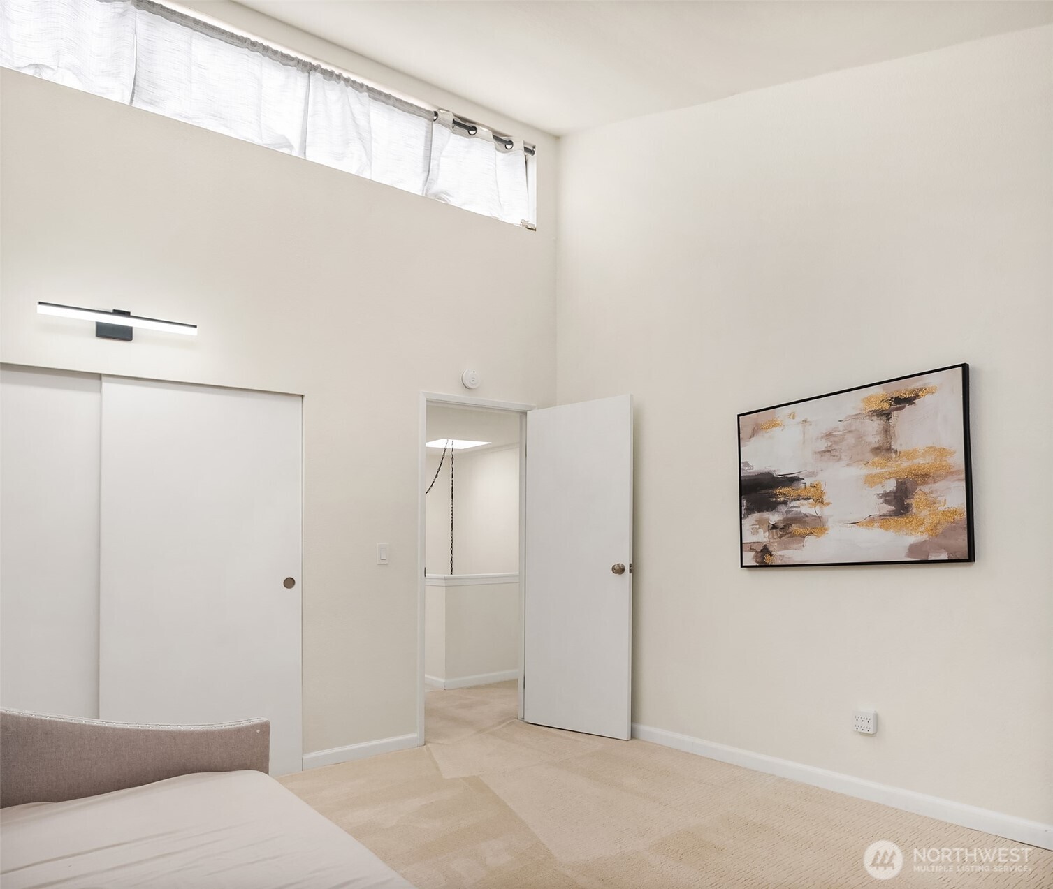 6582 137th Avenue Northeast, Unit 414 Redmond, WA 98052 - Photo 19 of 28 a bedroom with a bed and a painting on the wall