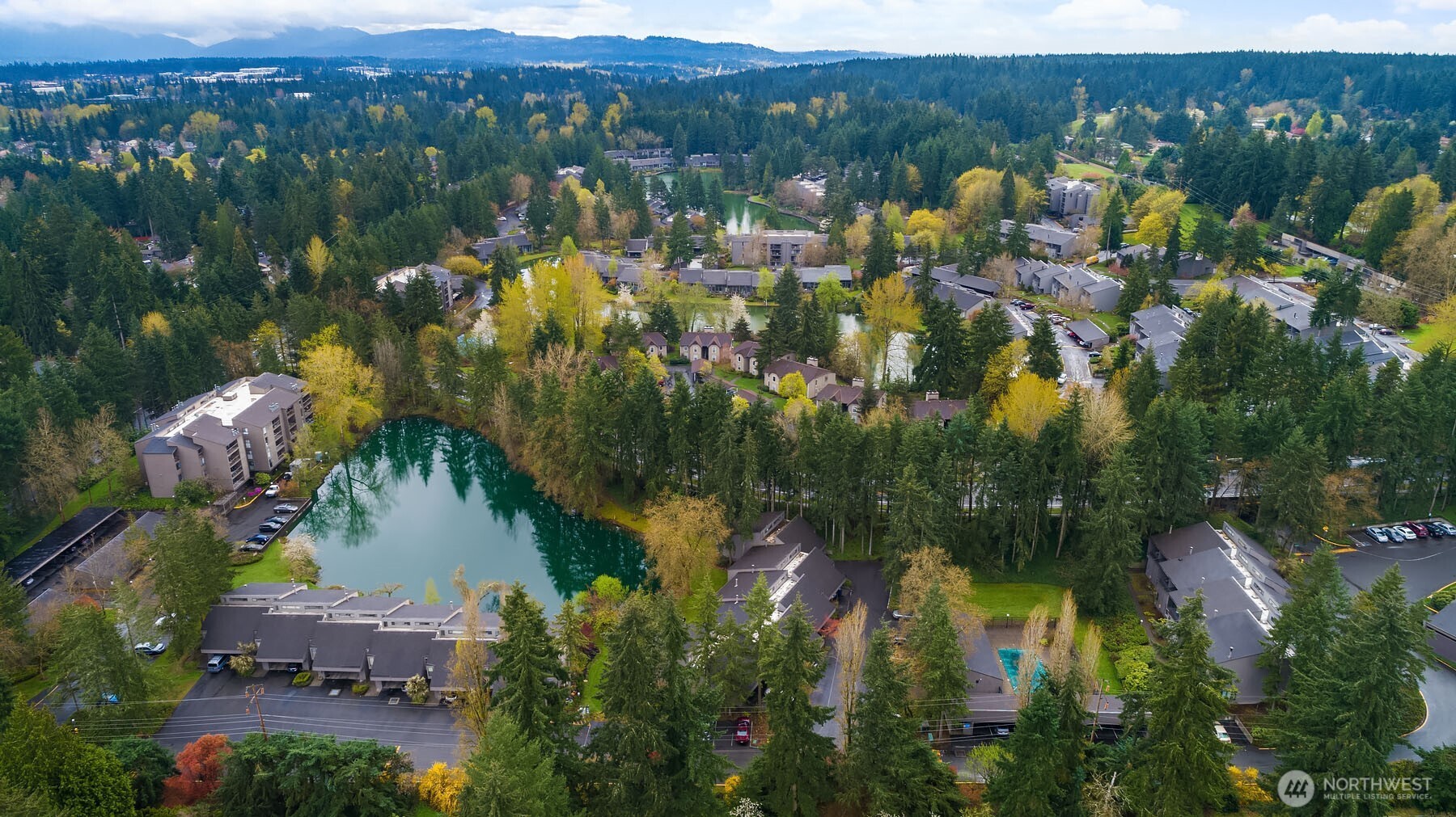 6582 137th Avenue Northeast, Unit 414 Redmond, WA 98052 - Photo 3 of 28 an aerial view of residential houses with outdoor space and swimming pool