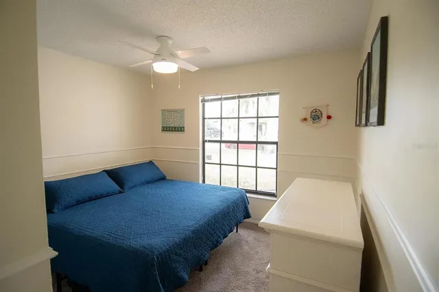 a bedroom with a bed and window