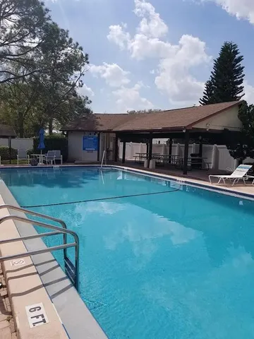 a view of a house with backyard and deck
