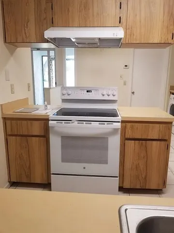 a stove top oven sitting inside of a kitchen