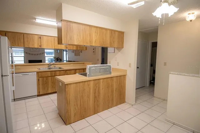a kitchen with a stove a refrigerator and a sink