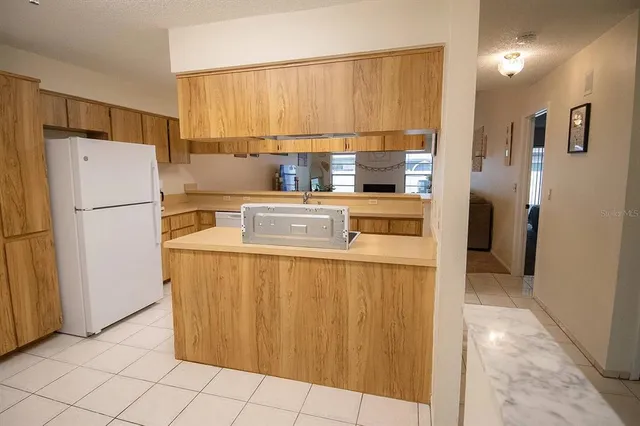 a white refrigerator freezer sitting inside of a kitchen