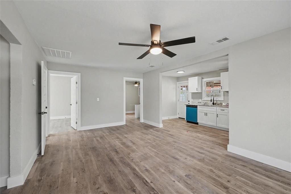 4220 Ramey Avenue Fort Worth, TX 76105 - Photo 6 of 24 a view of empty room with wooden floor and window