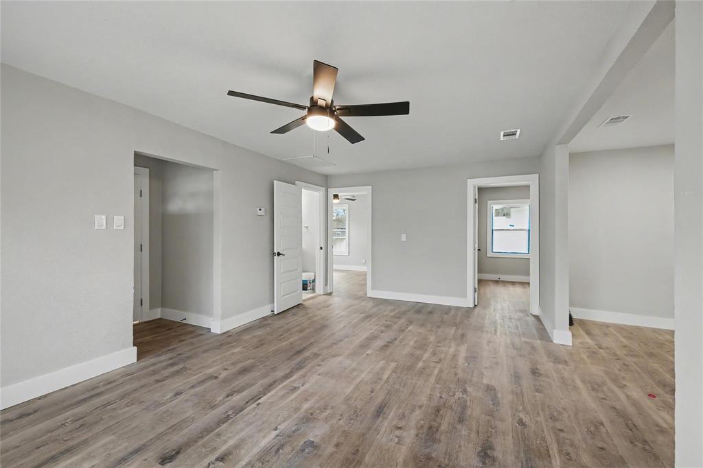 4220 Ramey Avenue Fort Worth, TX 76105 - Photo 7 of 24 a view of empty room with wooden floor and ceiling fan