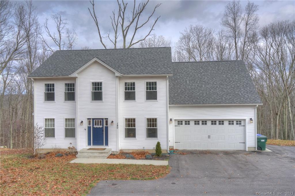 a view of a house with a yard and garage