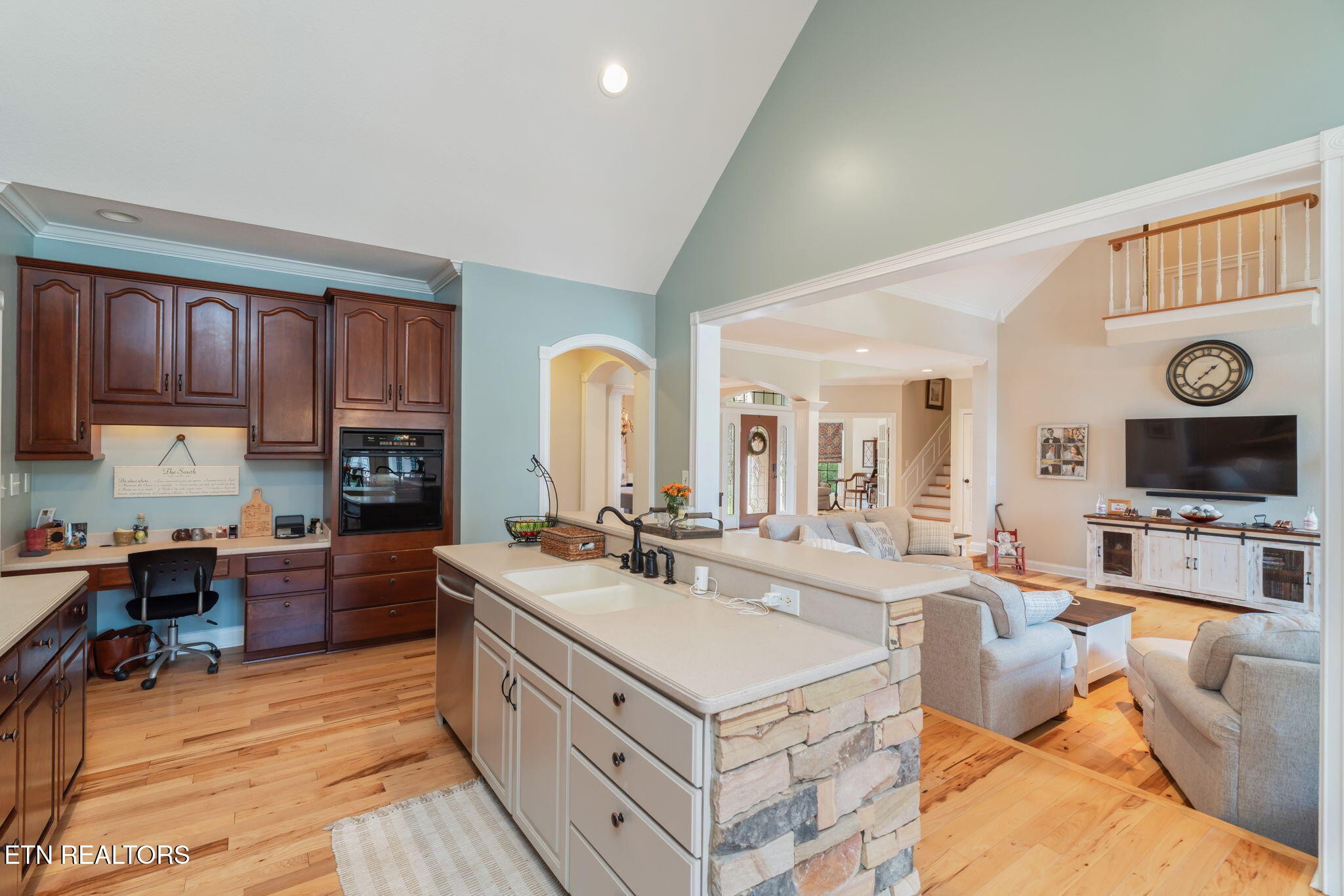 2572 Little Valley Road Loudon, TN 37774 - Photo 14 of 57 a large living room with stainless steel appliances granite countertop a couch a stove a kitchen island a dining table and chairs with wooden floor