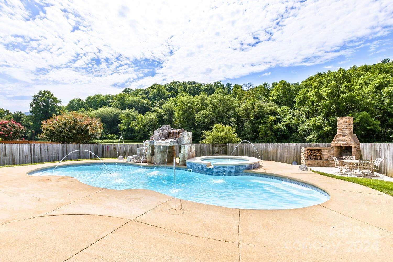 385 Wildbriar Road Fletcher, NC 28732 - Photo 38 of 42 a swimming pool with barbeque oven in front of it