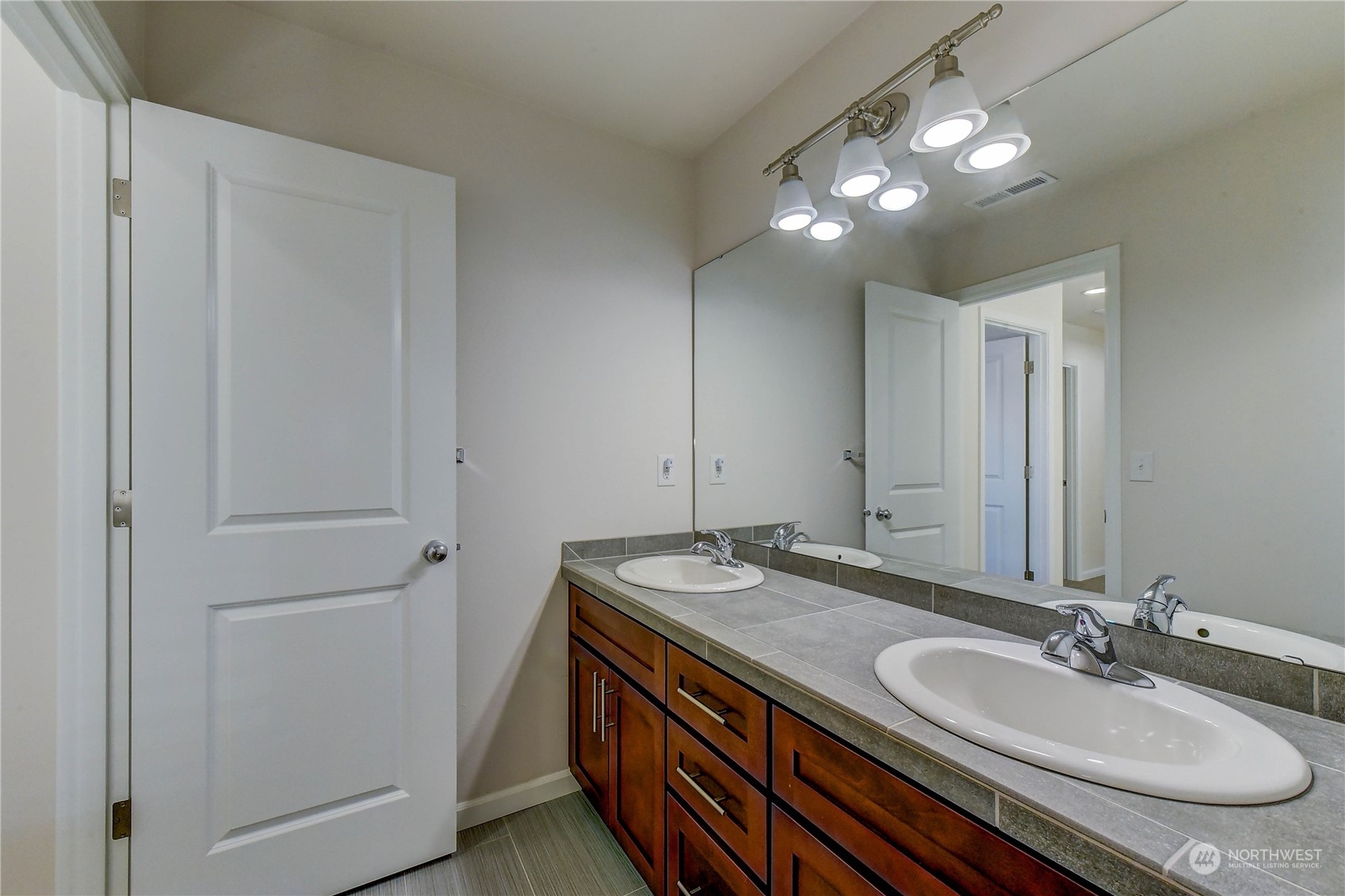 4501 30th Drive Southeast Everett, WA 98203 - Photo 12 of 29 a bathroom with a granite countertop double vanity sink and a mirror