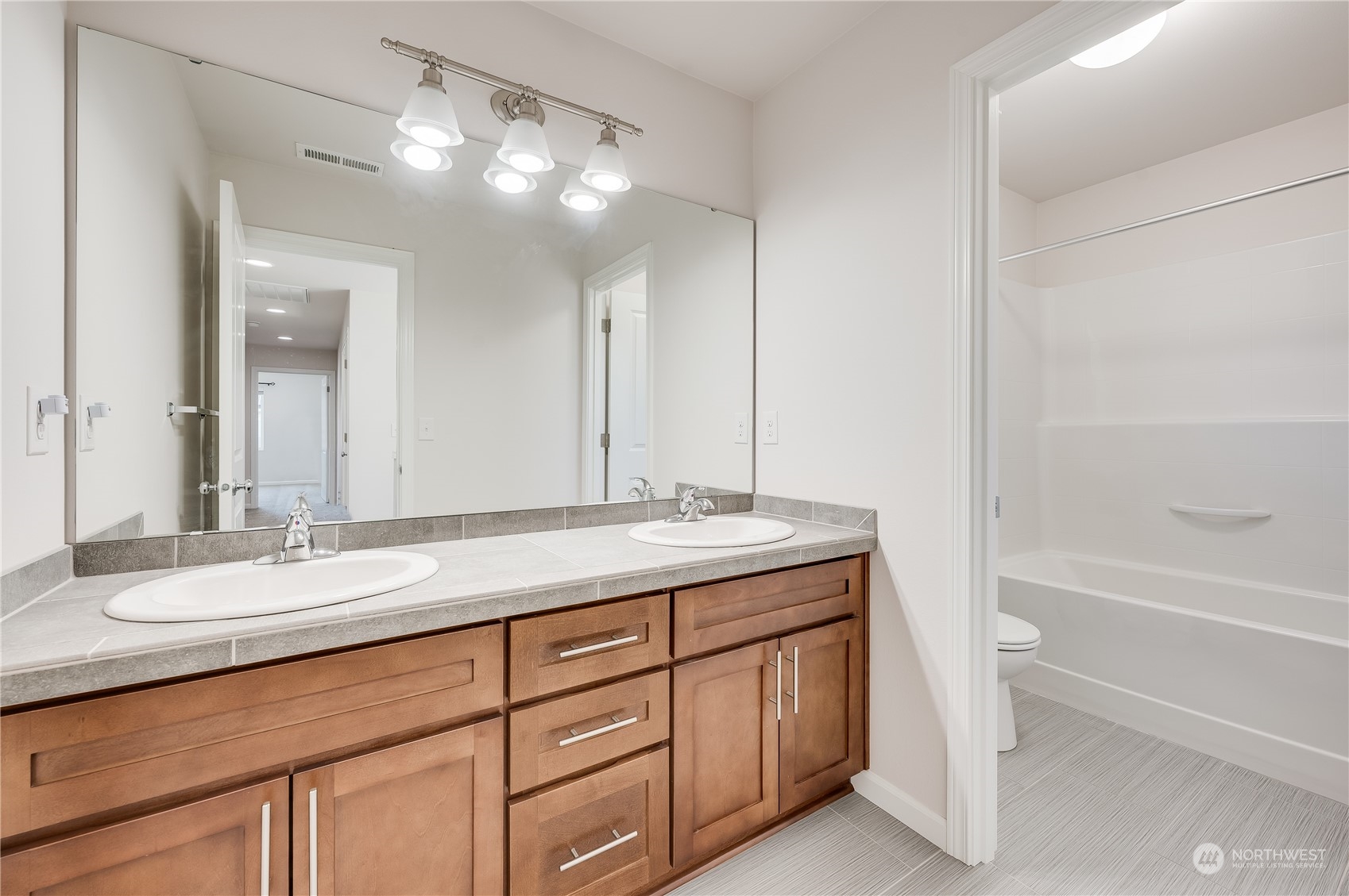 4501 30th Drive Southeast Everett, WA 98203 - Photo 26 of 29 a bathroom with a granite countertop sink mirror and a