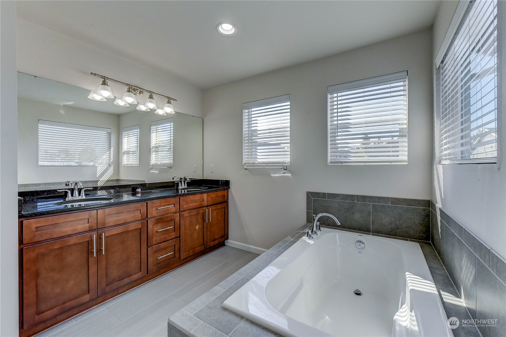 4501 30th Drive Southeast Everett, WA 98203 - Photo 10 of 29 a bathroom with a tub a sink a mirror and a window