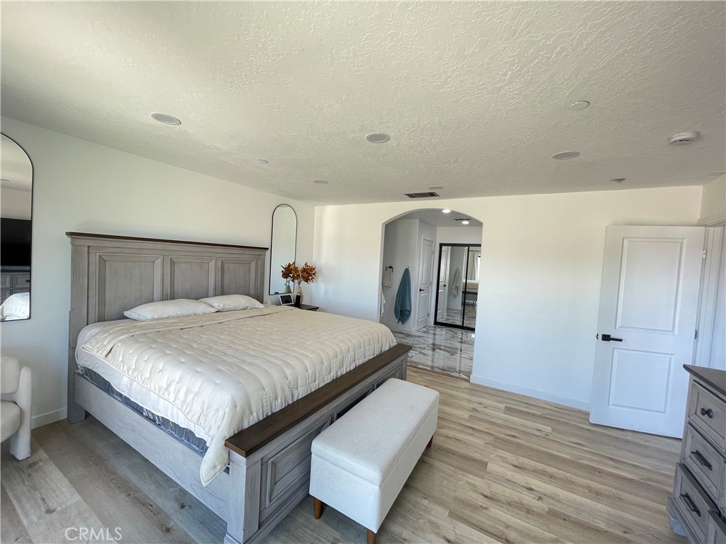 11375 4th Hesperia, CA 92345 - Photo 13 of 37 a bedroom with a bed and wooden floor