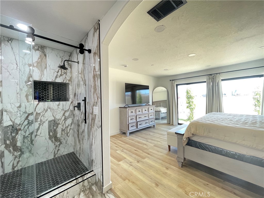 11375 4th Hesperia, CA 92345 - Photo 15 of 37 a spacious bedroom with a bed and a flat screen tv