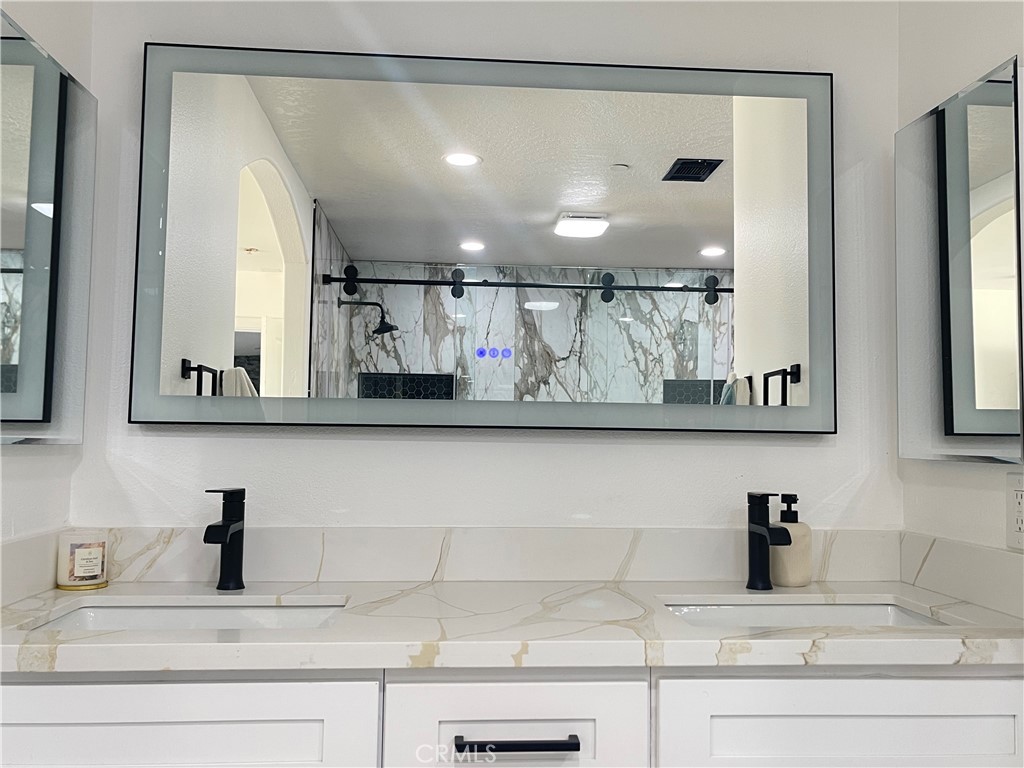 11375 4th Hesperia, CA 92345 - Photo 17 of 37 a view of bathroom with a sink and a mirror