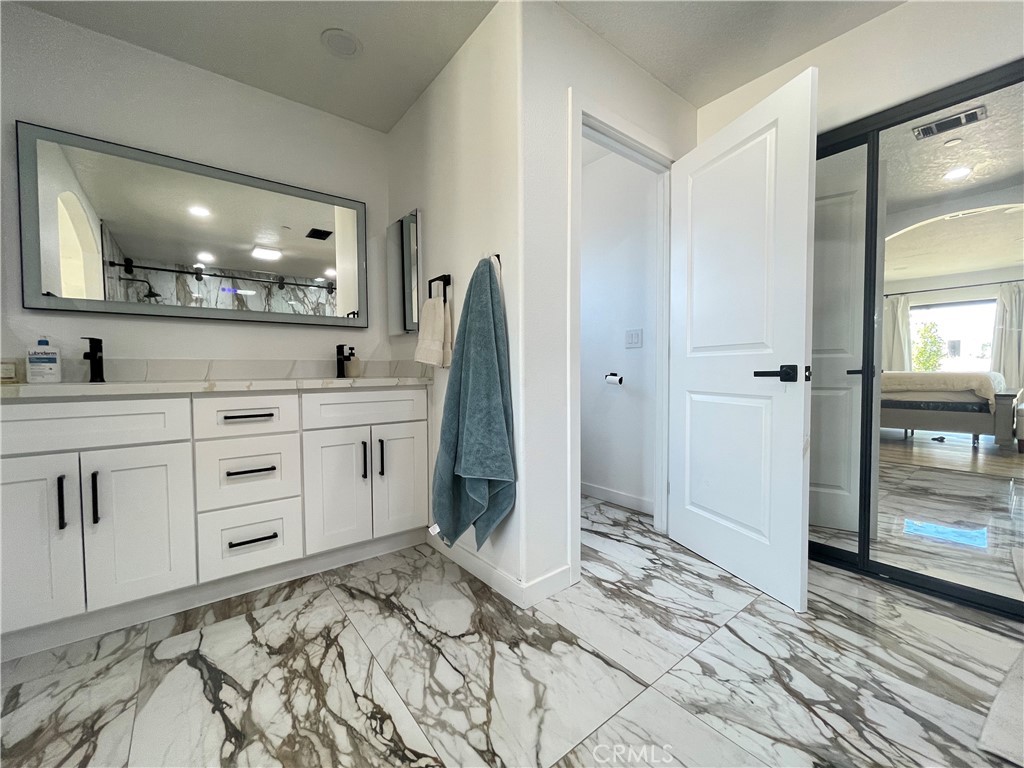 11375 4th Hesperia, CA 92345 - Photo 18 of 37 a spacious bathroom with a shower sink and mirror
