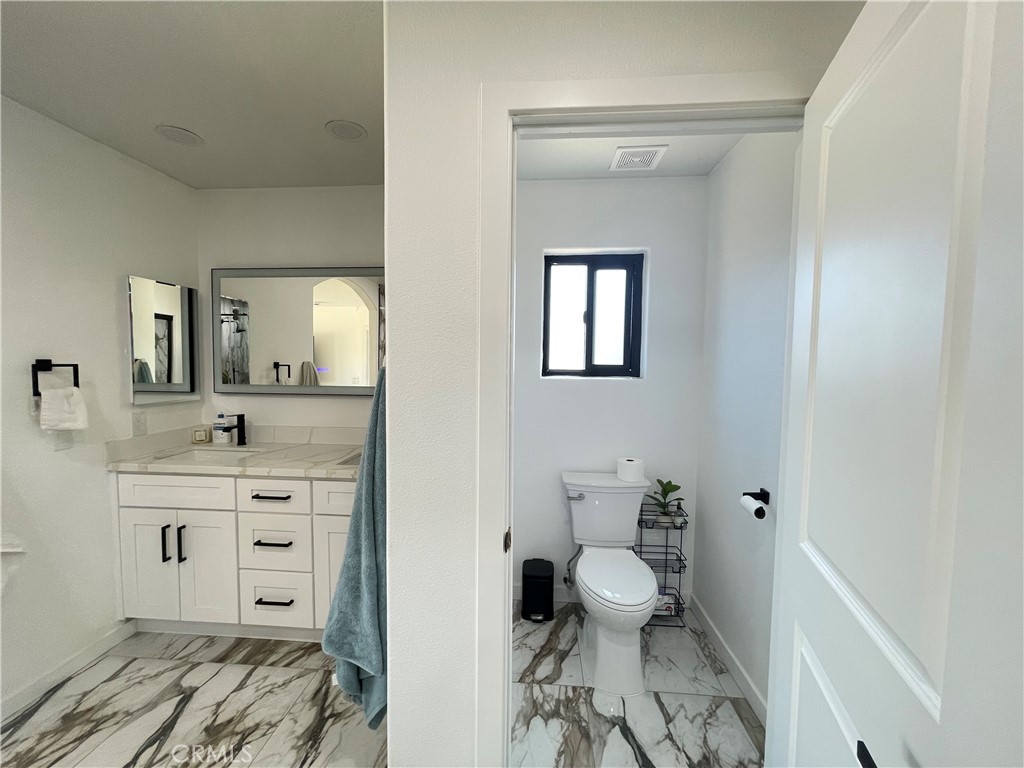 11375 4th Hesperia, CA 92345 - Photo 19 of 37 a bathroom with a sink vanity mirror and toilet