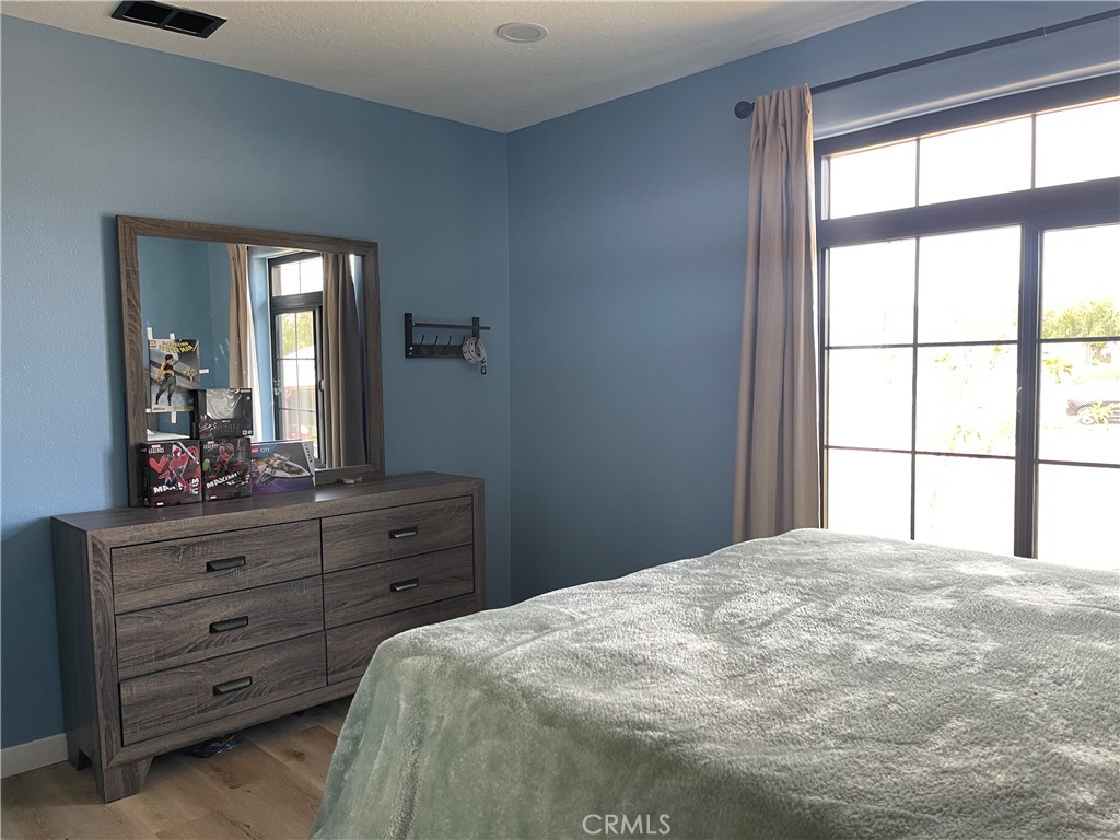 11375 4th Hesperia, CA 92345 - Photo 22 of 37 a bedroom with a bed and a dresser