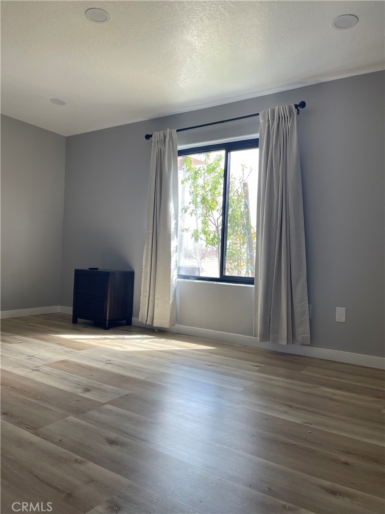 11375 4th Hesperia, CA 92345 - Photo 25 of 37 a view of an empty room with wooden floor and a window