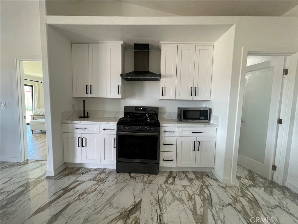 11375 4th Hesperia, CA 92345 - Photo 31 of 37 a kitchen with a stove a refrigerator and cabinets