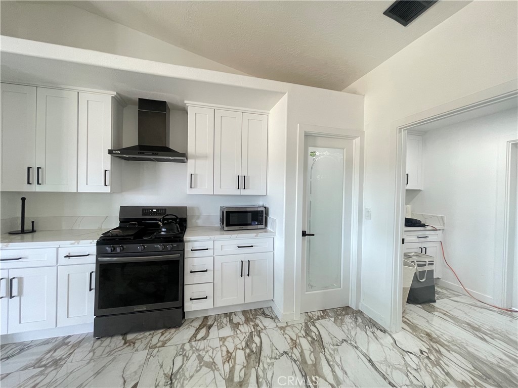 11375 4th Hesperia, CA 92345 - Photo 32 of 37 a kitchen with a stove and a refrigerator
