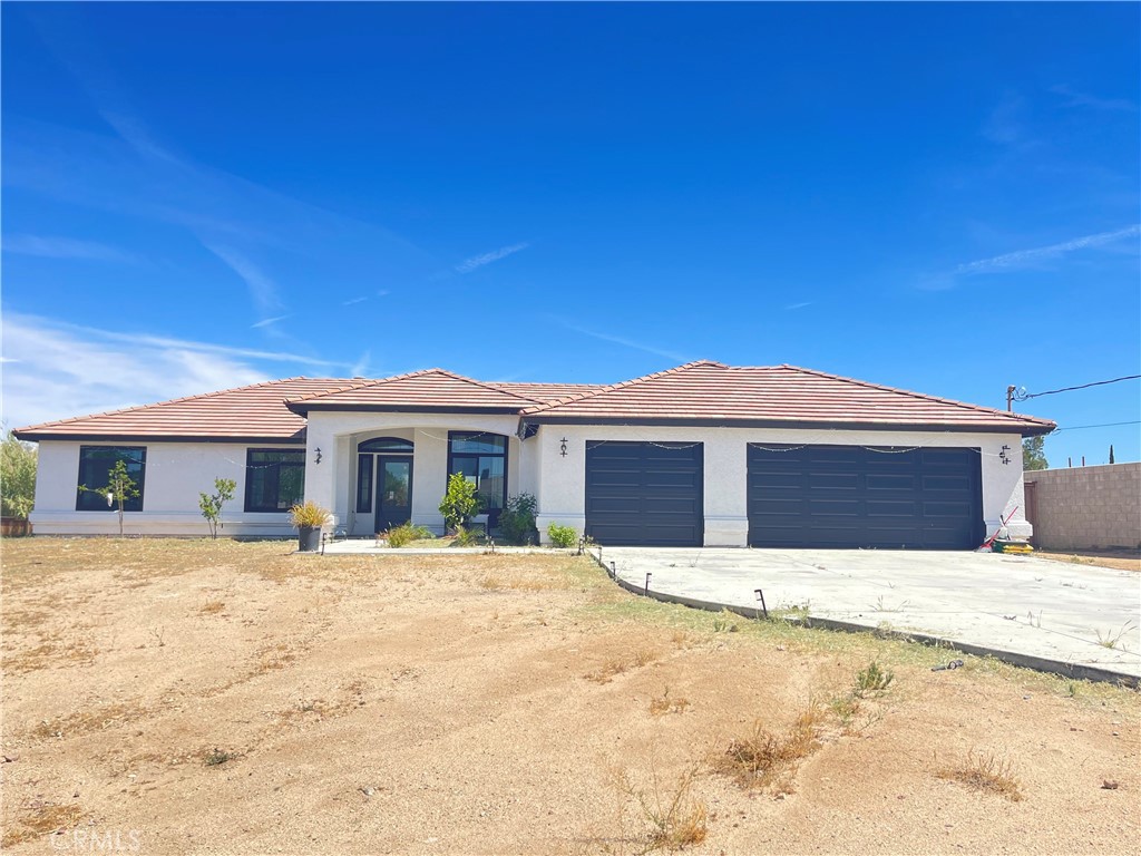 11375 4th Hesperia, CA 92345 - Photo 4 of 37 a front view of a house with a yard